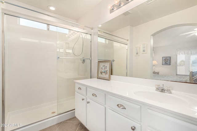 bathroom with walk in shower, vanity, tile patterned floors, and ceiling fan