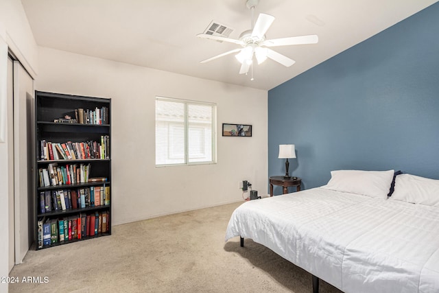 carpeted bedroom with a closet and ceiling fan