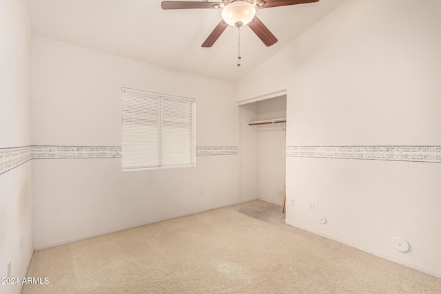 unfurnished bedroom featuring ceiling fan, light colored carpet, and vaulted ceiling