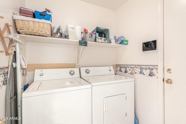 clothes washing area with washing machine and dryer