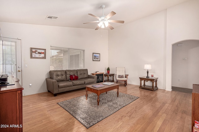 living room with ceiling fan and light wood-type flooring