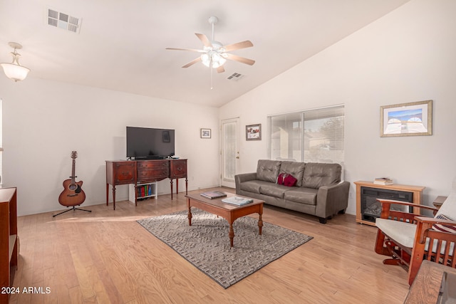 living room with ceiling fan, light hardwood / wood-style flooring, and high vaulted ceiling