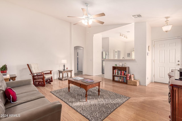 living room with light hardwood / wood-style flooring and ceiling fan