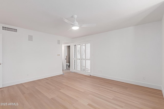 unfurnished room with baseboards, visible vents, light wood finished floors, and ceiling fan