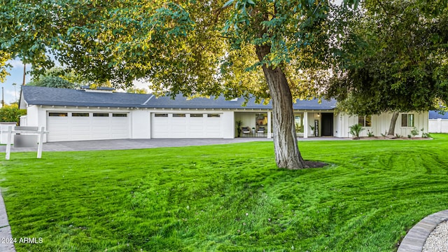 view of front of house with a front yard and a garage