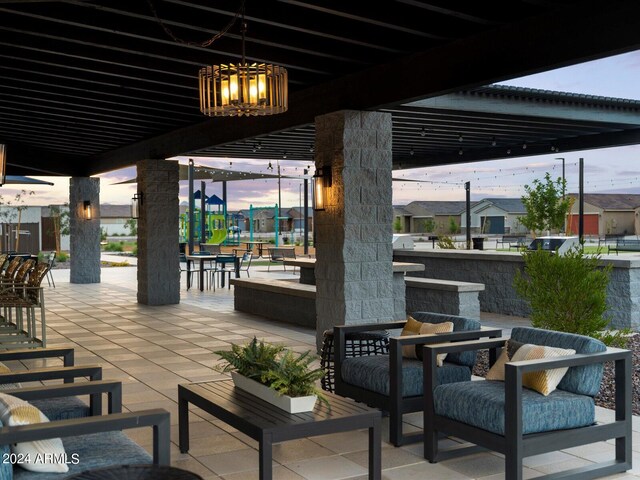 patio terrace at dusk featuring an outdoor living space