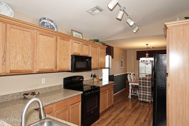 kitchen featuring sink, light stone counters, dark hardwood / wood-style floors, a chandelier, and black appliances