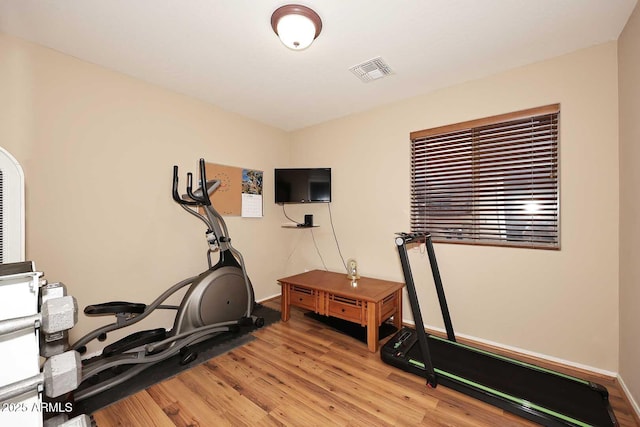 workout area with light hardwood / wood-style floors