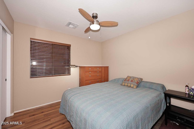 bedroom with ceiling fan, a closet, and dark hardwood / wood-style flooring