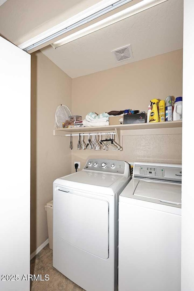 clothes washing area featuring washer and dryer