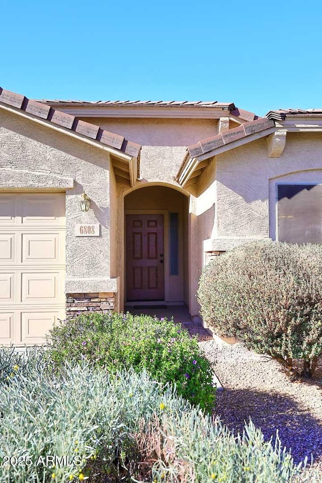 doorway to property featuring a garage