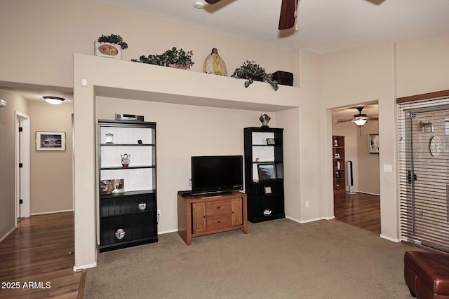 living room with a high ceiling and dark colored carpet