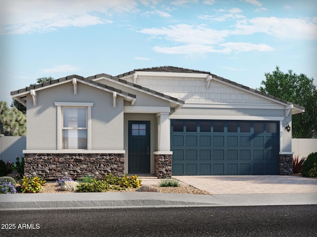 5573 S 246th Ave, Buckeye, AZ 85326 - craftsman house featuring stone siding, decorative driveway, a garage, and stucco siding