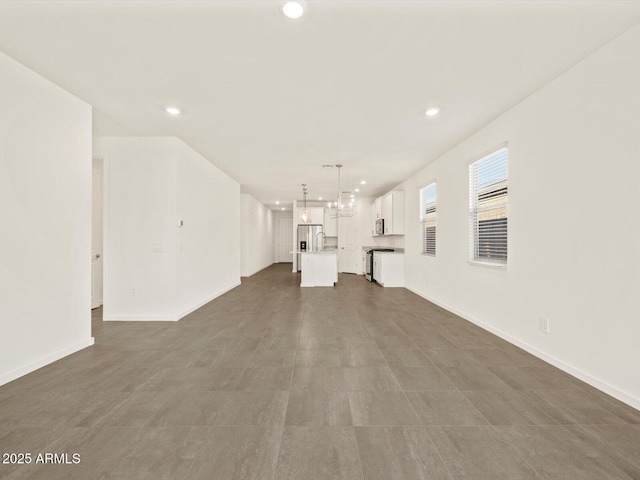 5573 S 246th Ave, Buckeye, AZ 85326 - unfurnished living room with recessed lighting and baseboards