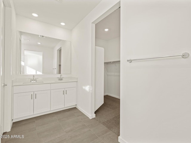 5573 S 246th Ave, Buckeye, AZ 85326 - full bathroom with double vanity, a spacious closet, and recessed lighting