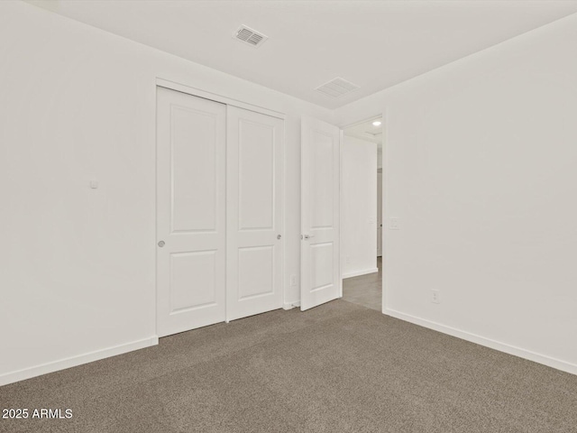 5573 S 246th Ave, Buckeye, AZ 85326 - unfurnished bedroom with dark colored carpet and a closet