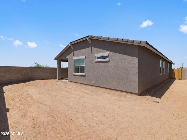 5573 S 246th Ave, Buckeye, AZ 85326 - rear view of house with a fenced backyard and stucco siding