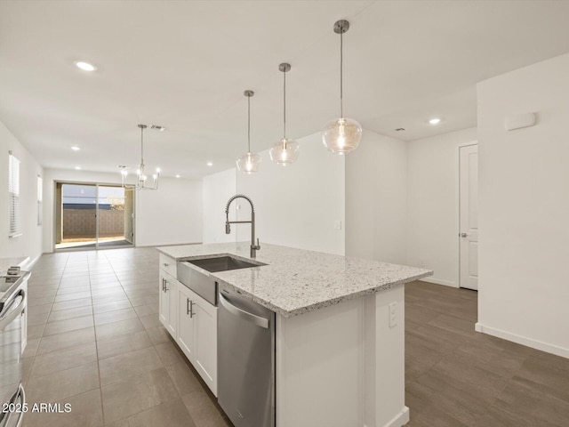 5573 S 246th Ave, Buckeye, AZ 85326 - kitchen featuring stainless steel appliances, open floor plan, white cabinetry, a kitchen island with sink, and light stone counters