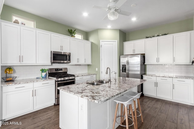 21716 E Waverly Dr, Queen Creek, AZ 85142 - kitchen featuring stainless steel appliances, sink, a center island with sink, and white cabinets