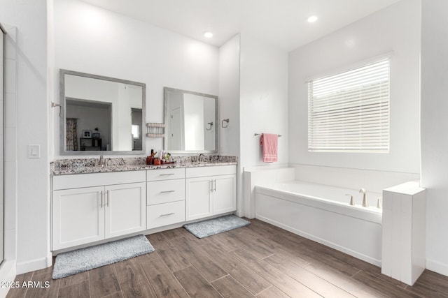 21716 E Waverly Dr, Queen Creek, AZ 85142 - bathroom featuring vanity, hardwood / wood-style floors, and a tub