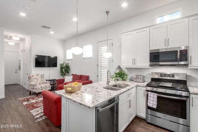 21716 E Waverly Dr, Queen Creek, AZ 85142 - kitchen featuring appliances with stainless steel finishes, decorative light fixtures, sink, white cabinets, and backsplash
