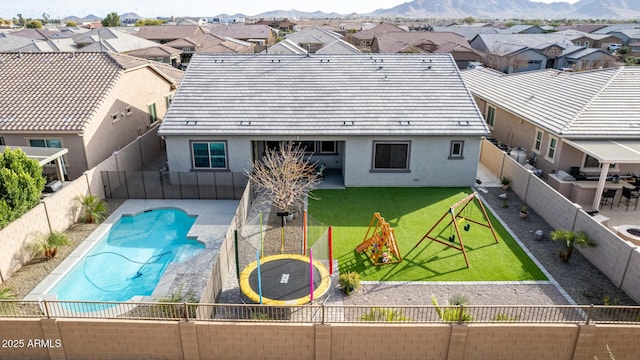 21716 E Waverly Dr, Queen Creek, AZ 85142 - exterior space featuring a trampoline, a lawn, a mountain view, a fenced in pool, and a patio