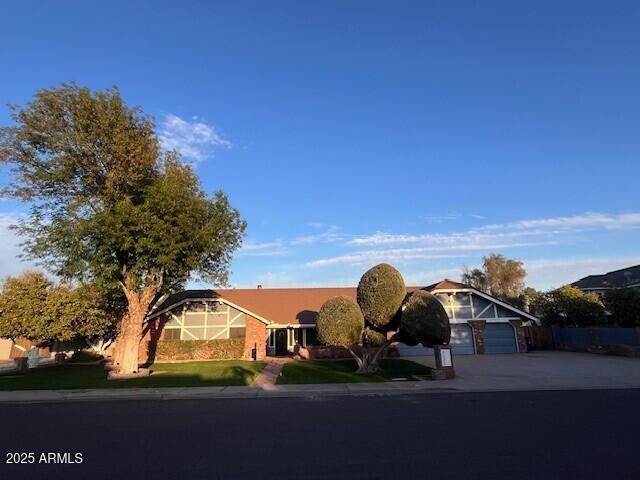 ranch-style home featuring an attached garage and driveway