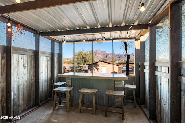 sunroom with a mountain view and indoor bar