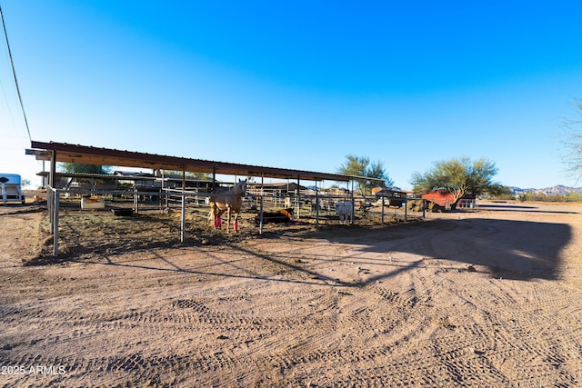 view of yard with a rural view and an outdoor structure