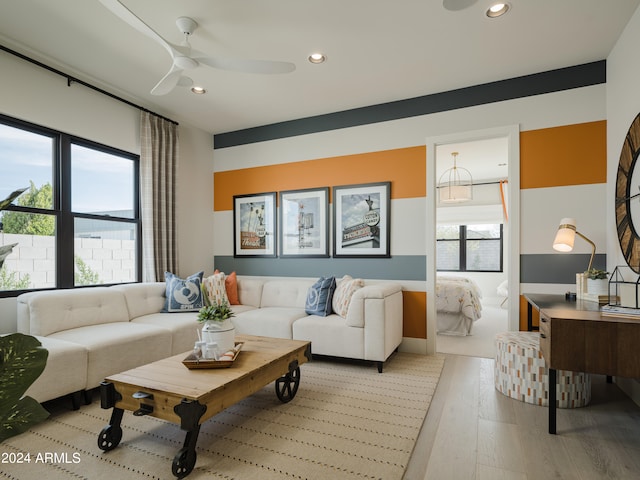 living room featuring ceiling fan and light wood-type flooring