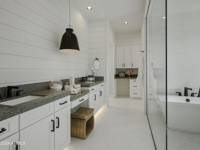 bathroom featuring tile floors, wooden walls, a shower with shower door, and dual vanity