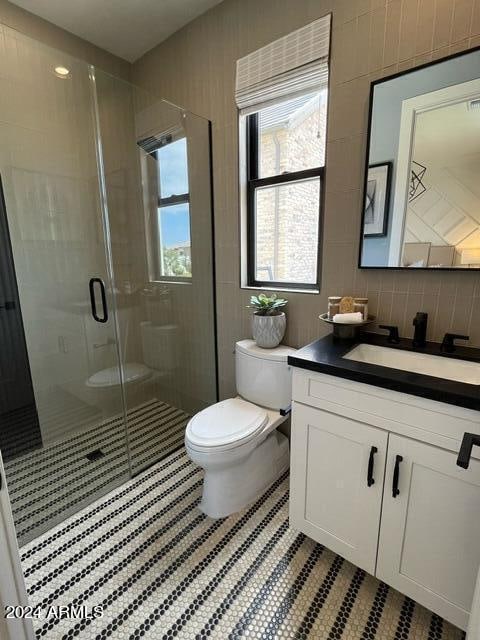 bathroom with walk in shower, tile floors, backsplash, vanity, and toilet