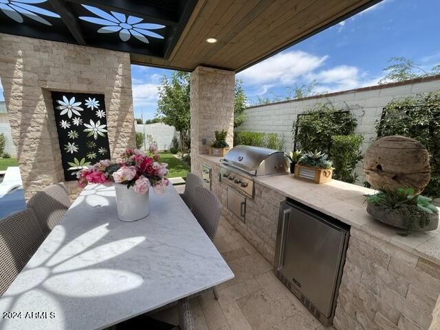 view of terrace featuring exterior kitchen and grilling area