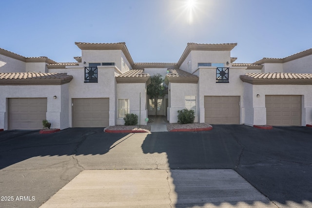 mediterranean / spanish-style house with a garage