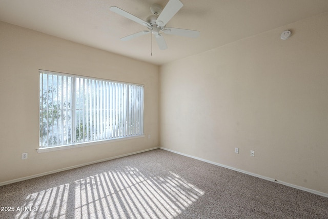 empty room with ceiling fan and carpet flooring