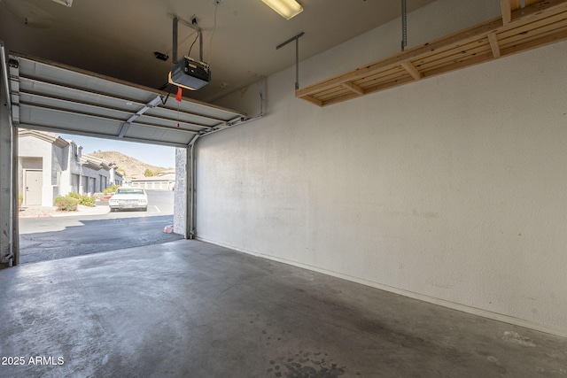 garage featuring a garage door opener and a mountain view