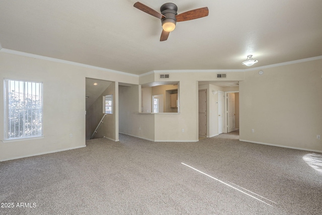 unfurnished living room with ceiling fan, ornamental molding, and carpet