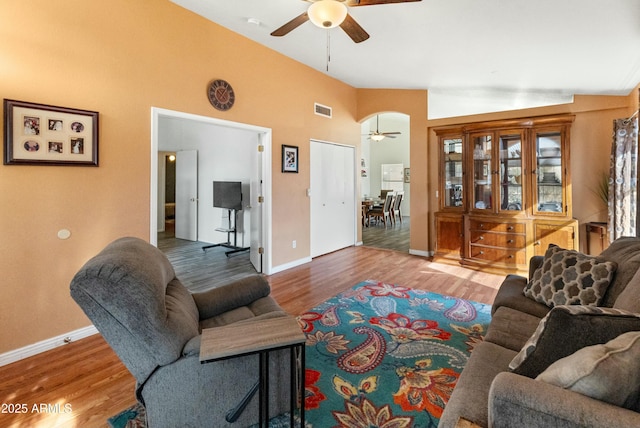 living room with ceiling fan, high vaulted ceiling, and hardwood / wood-style flooring