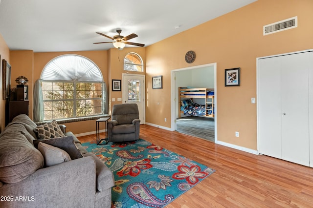 living room featuring ceiling fan and light hardwood / wood-style flooring