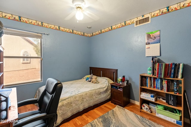 bedroom featuring light hardwood / wood-style flooring and ceiling fan