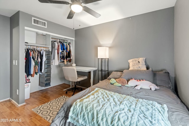 bedroom with light hardwood / wood-style floors, a closet, and ceiling fan