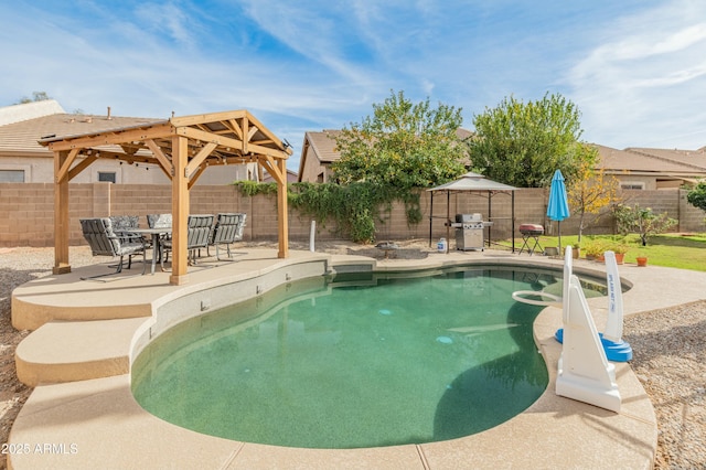 view of pool featuring a gazebo, a patio, and a grill