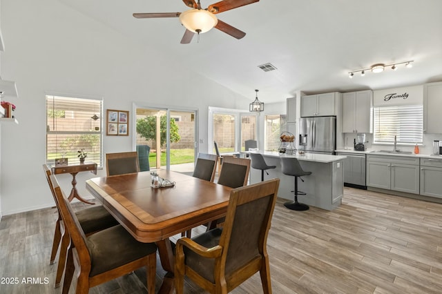 dining space with ceiling fan, sink, plenty of natural light, and light wood-type flooring