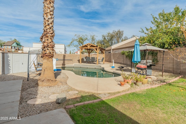 view of swimming pool with a gazebo, a shed, a patio area, and a grill