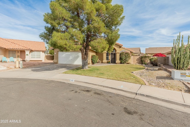 view of front of house featuring a front yard and a garage