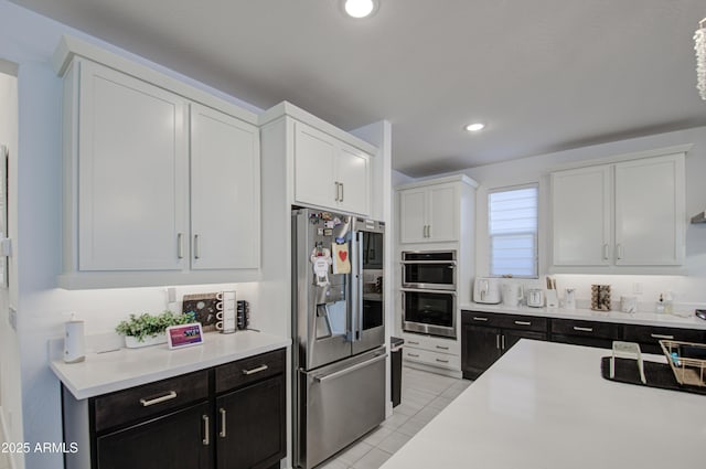 kitchen featuring white cabinetry, light tile patterned floors, and appliances with stainless steel finishes