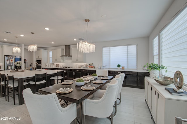 tiled dining area featuring sink and a chandelier