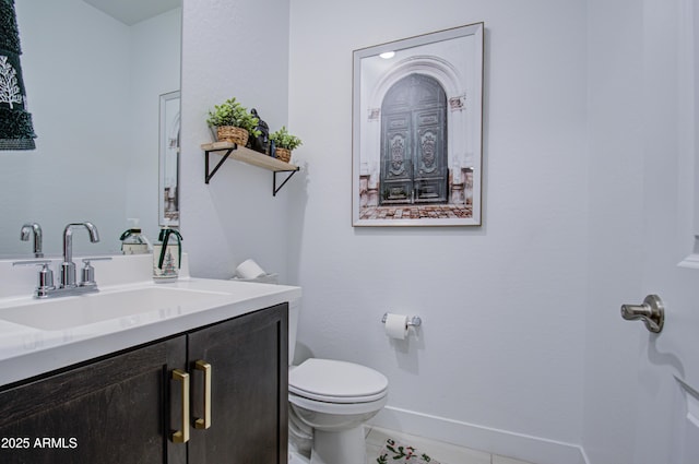 bathroom featuring tile patterned flooring, vanity, and toilet