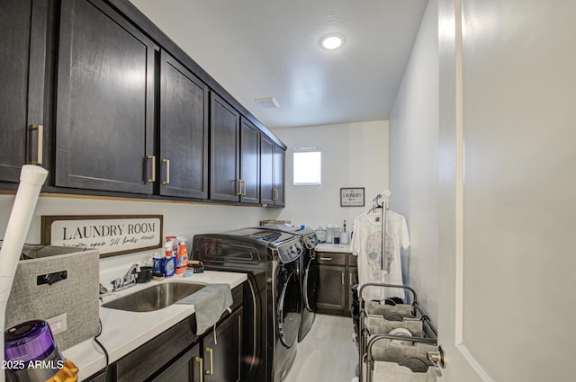 laundry area with cabinets, light tile patterned flooring, sink, and independent washer and dryer