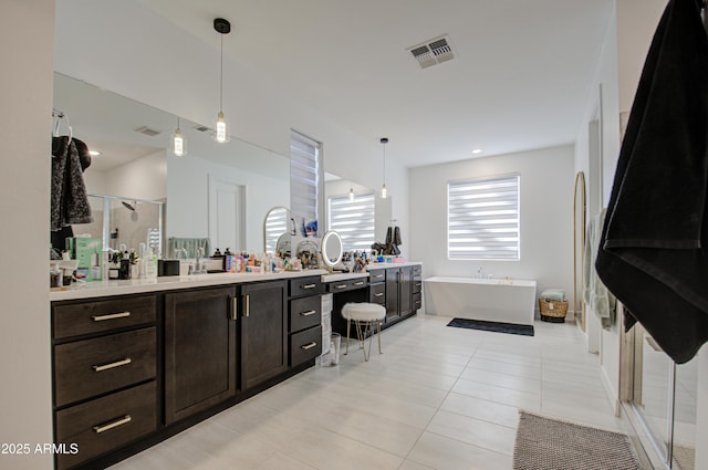 bathroom with independent shower and bath, vanity, and tile patterned flooring